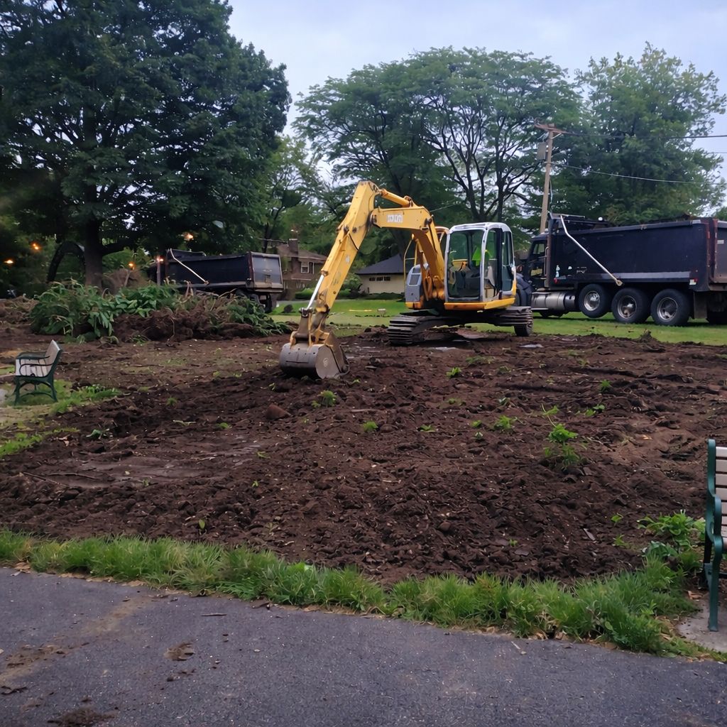 GradeCraft excavator performing land clearing on residential backyard in New Jersey